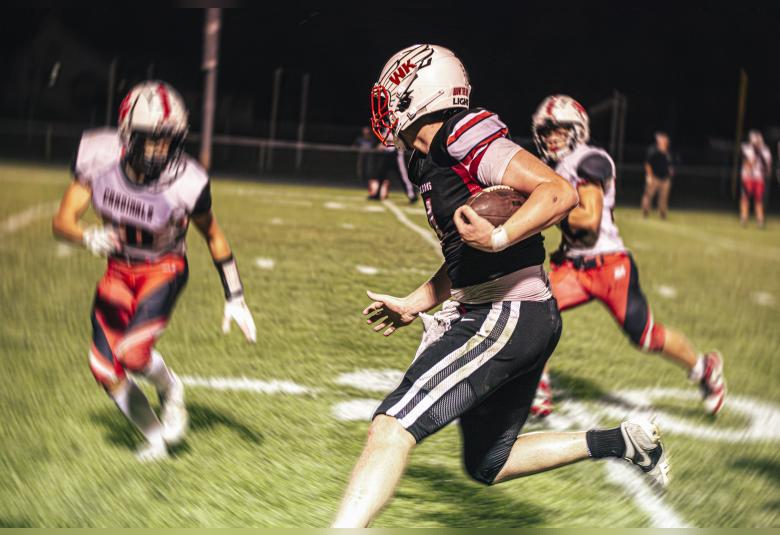 Bryar Ender, no. 4 Falcon Captain, receives and runs 40 yards as the clock runs out in the first half, eventually tackled by three Cardinals just a few yards short of the end zone.  Photos by Sophie Horgan | Editor